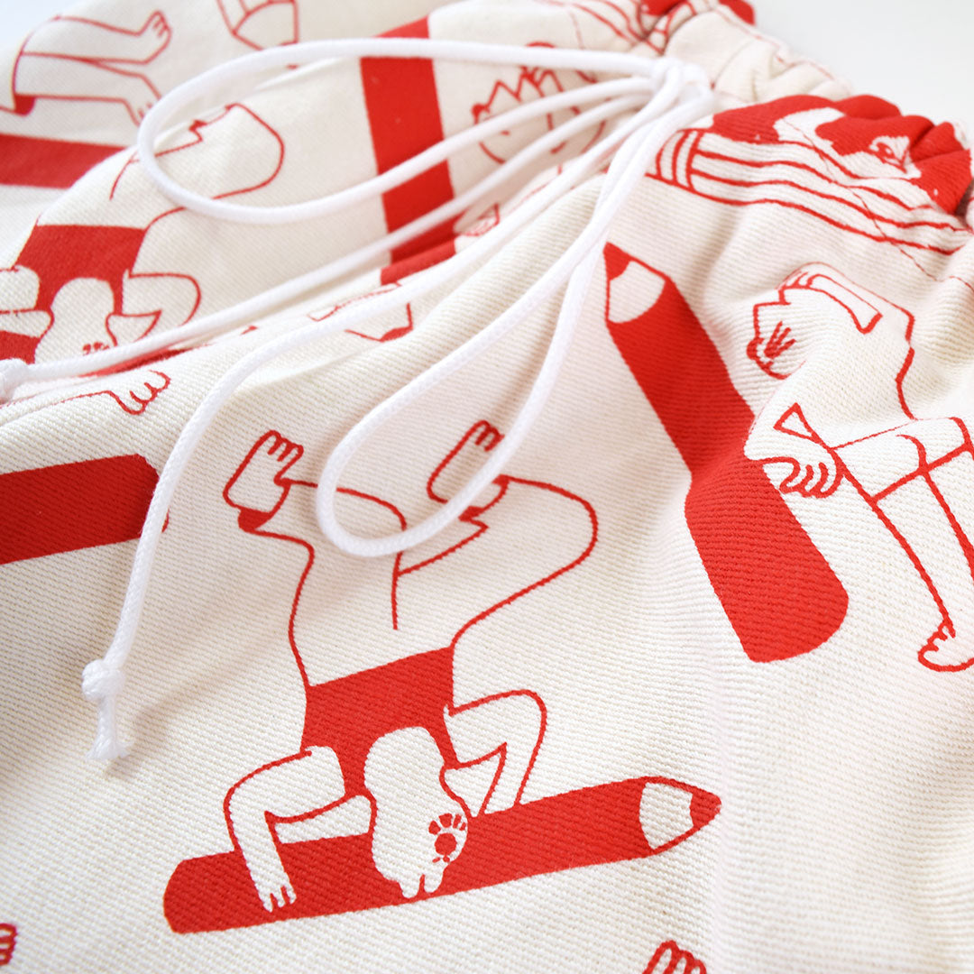 Close up of the red Artist Suit trousers, hand made and hand screen printed by YUK FUN