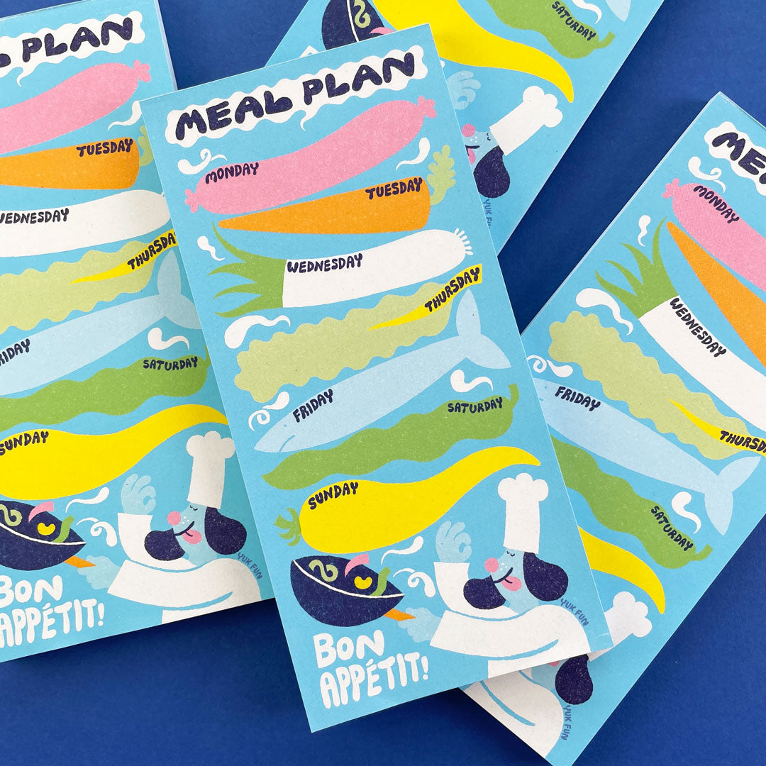 Close up photo of a colourful illustrated meal planner notepad designed by YUK FUN