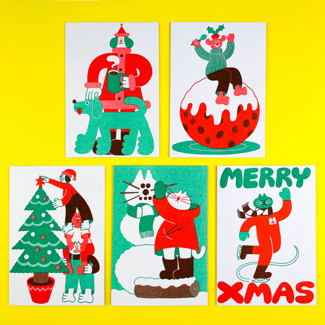 Five christmas cards on a yellow background. Top two are of Santa dog and their pet dog and a happy Christmas pudding eater on a giant Christmas pudding. Bottom three are christmas tree decorators, a snow cat being made and a smug cat ice skating. 