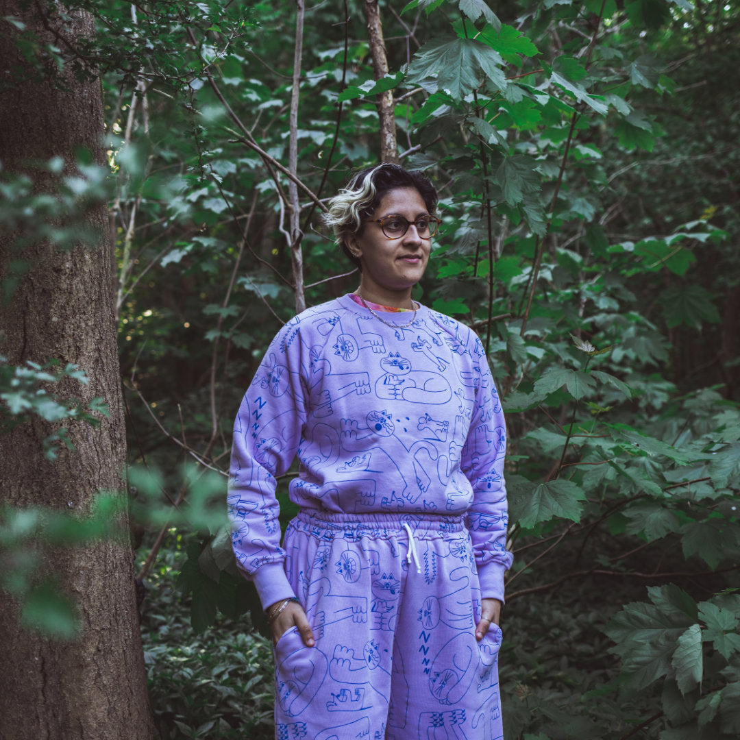 Unisex lilac all over cat print tracksuit made from 100% organic cotton fleece in the UK by indie brand YUK FUN