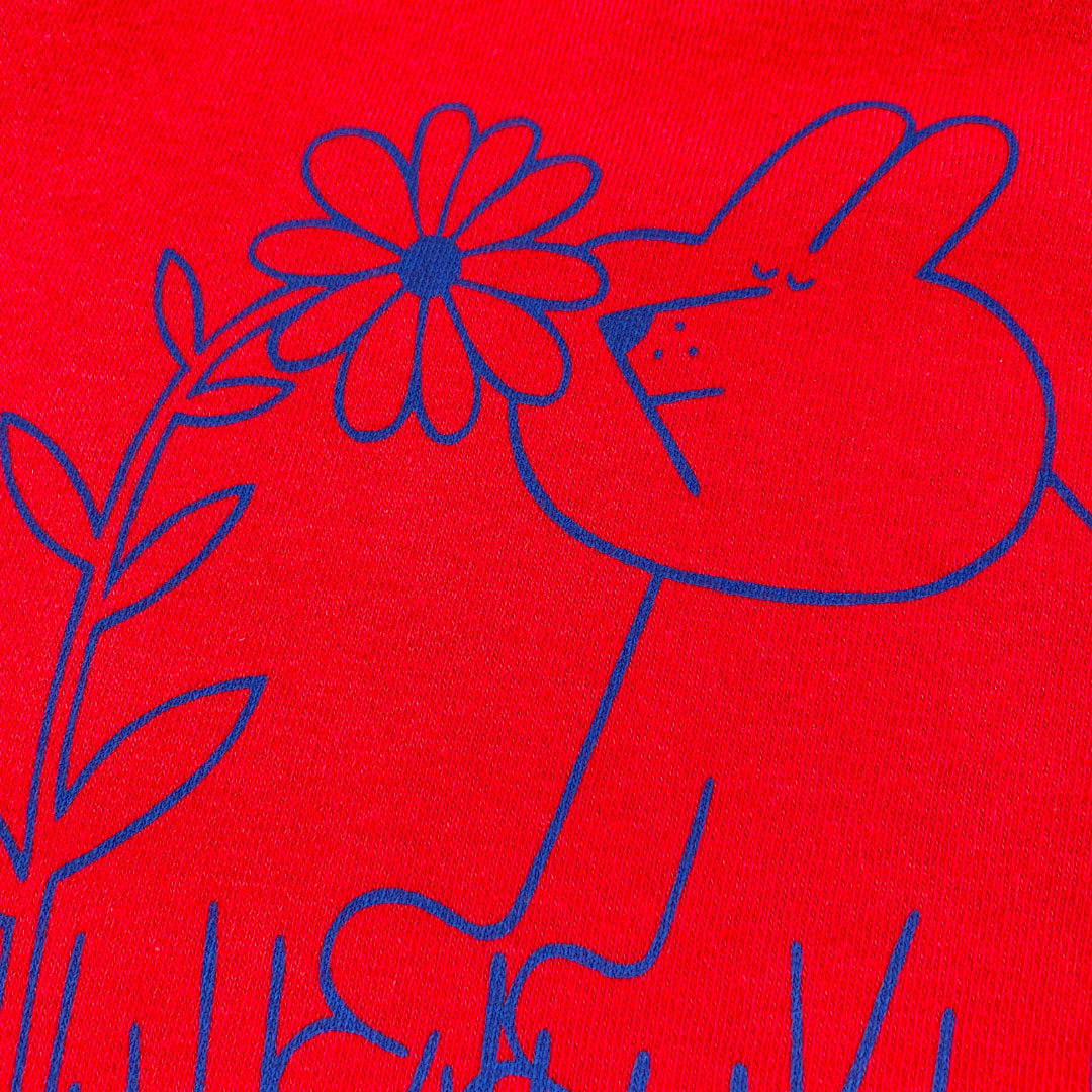 Close up detail of cute dog bunny having a good sniff of a nice flower by YUK FUN